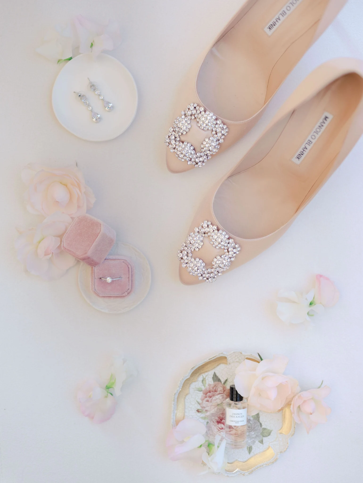 Wedding details: blush Manolo Blahnik shoes, engagement ring and delicate flowers