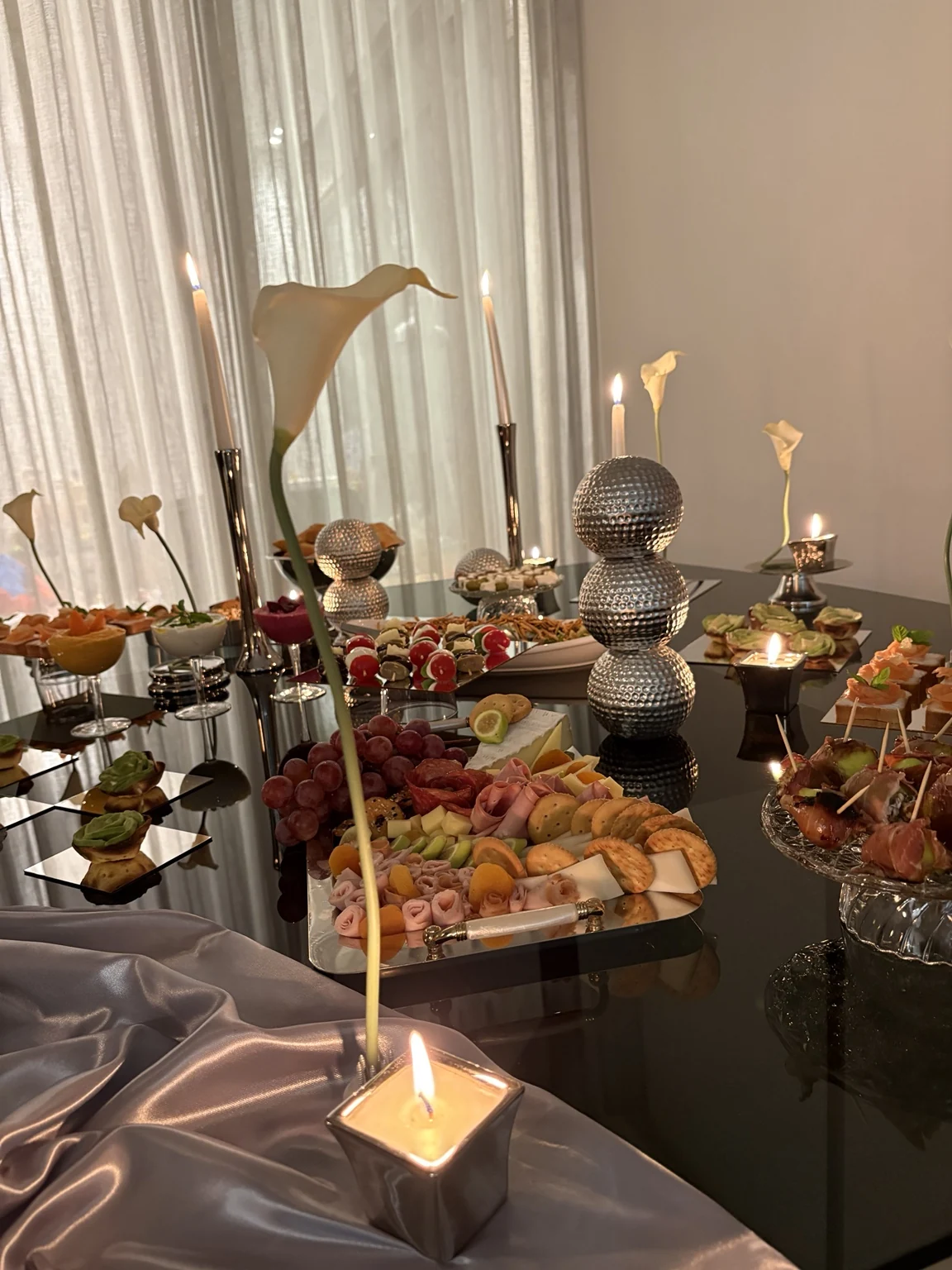 Close view of buffet with metallic sculpture and savory platters